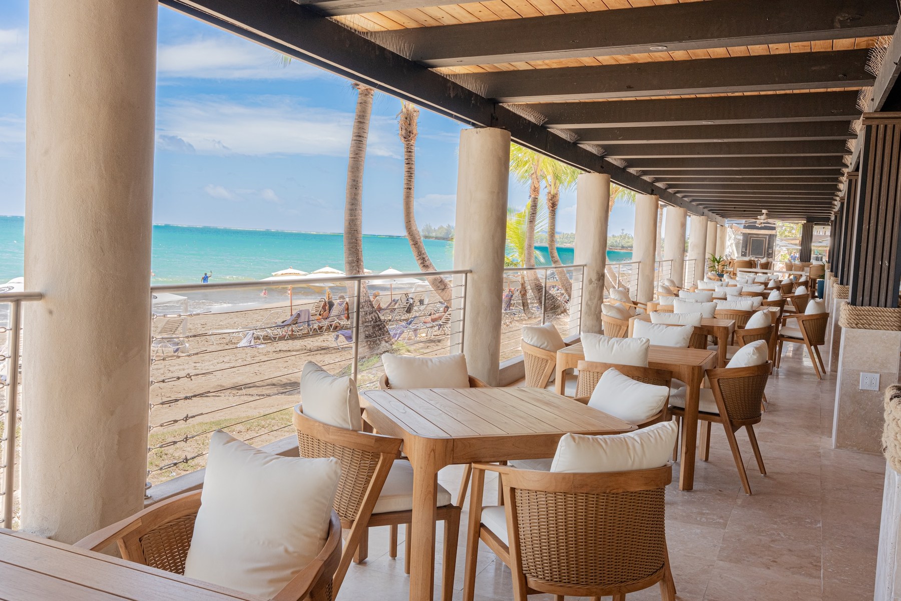Open-air Ocean Lab restaurant seating overlooking Isla Verde beach