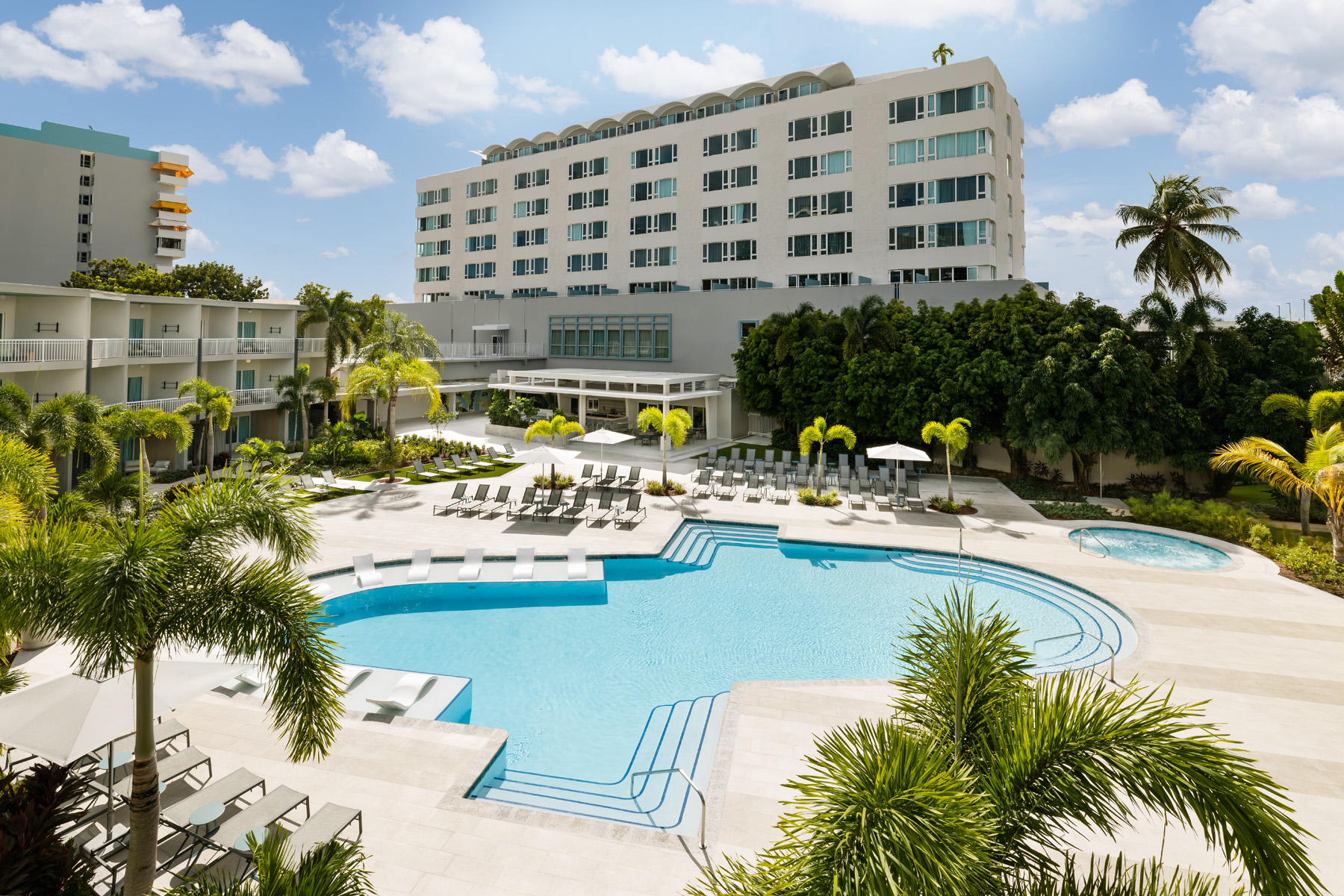 Hyatt Centric San Juan Isla Verde resort-style pool deck with palms and lounge chairs