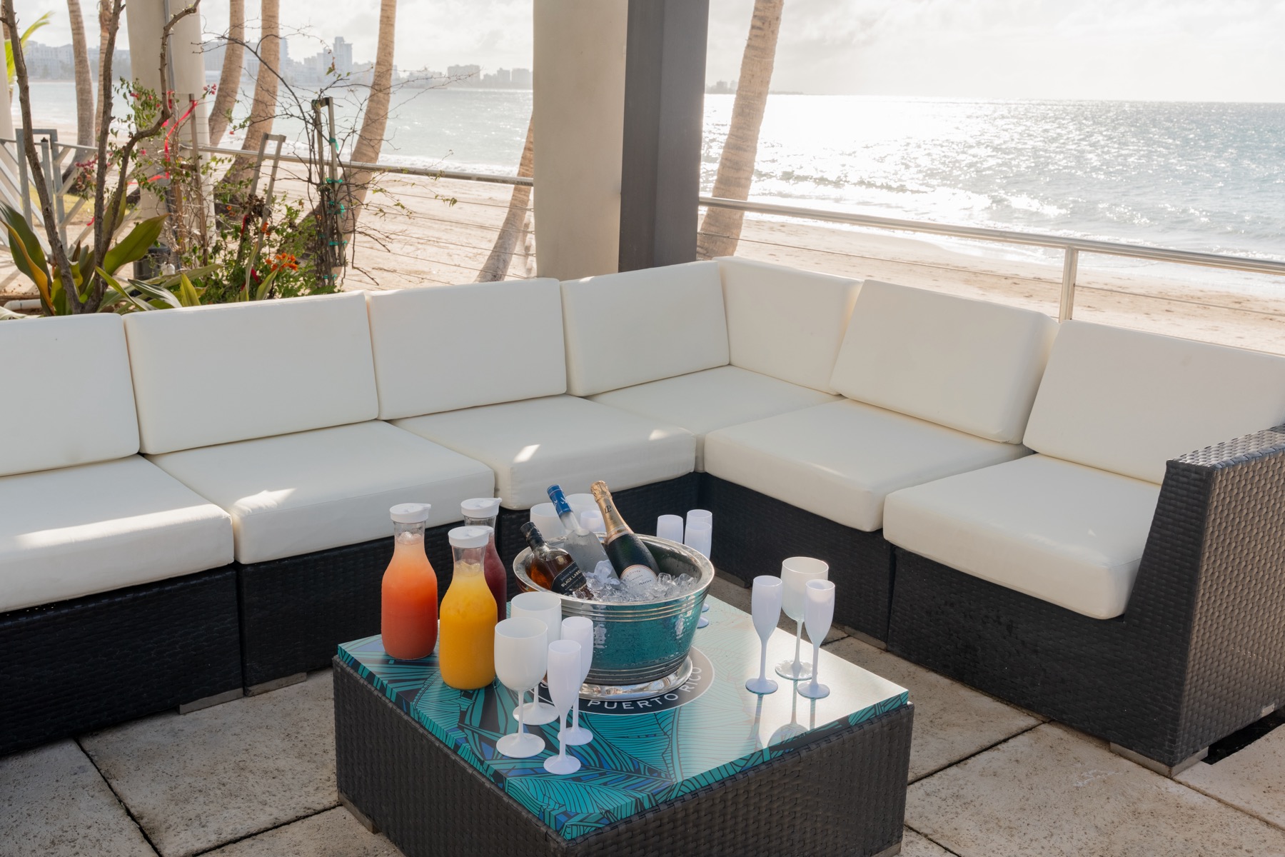 White lounge seating beside the Jacuzzi at Vivo Beach Club with ocean views