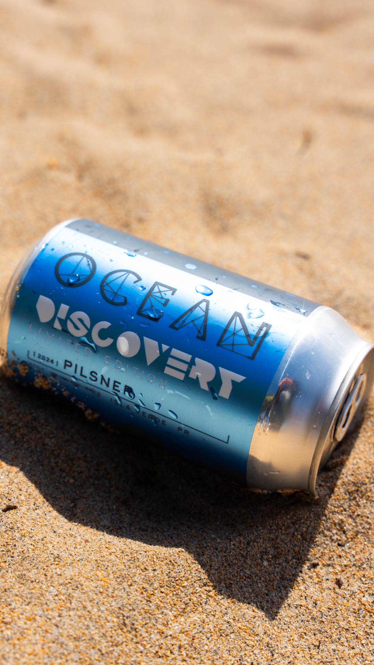 Ocean Lab Discover limited edition can on the sand