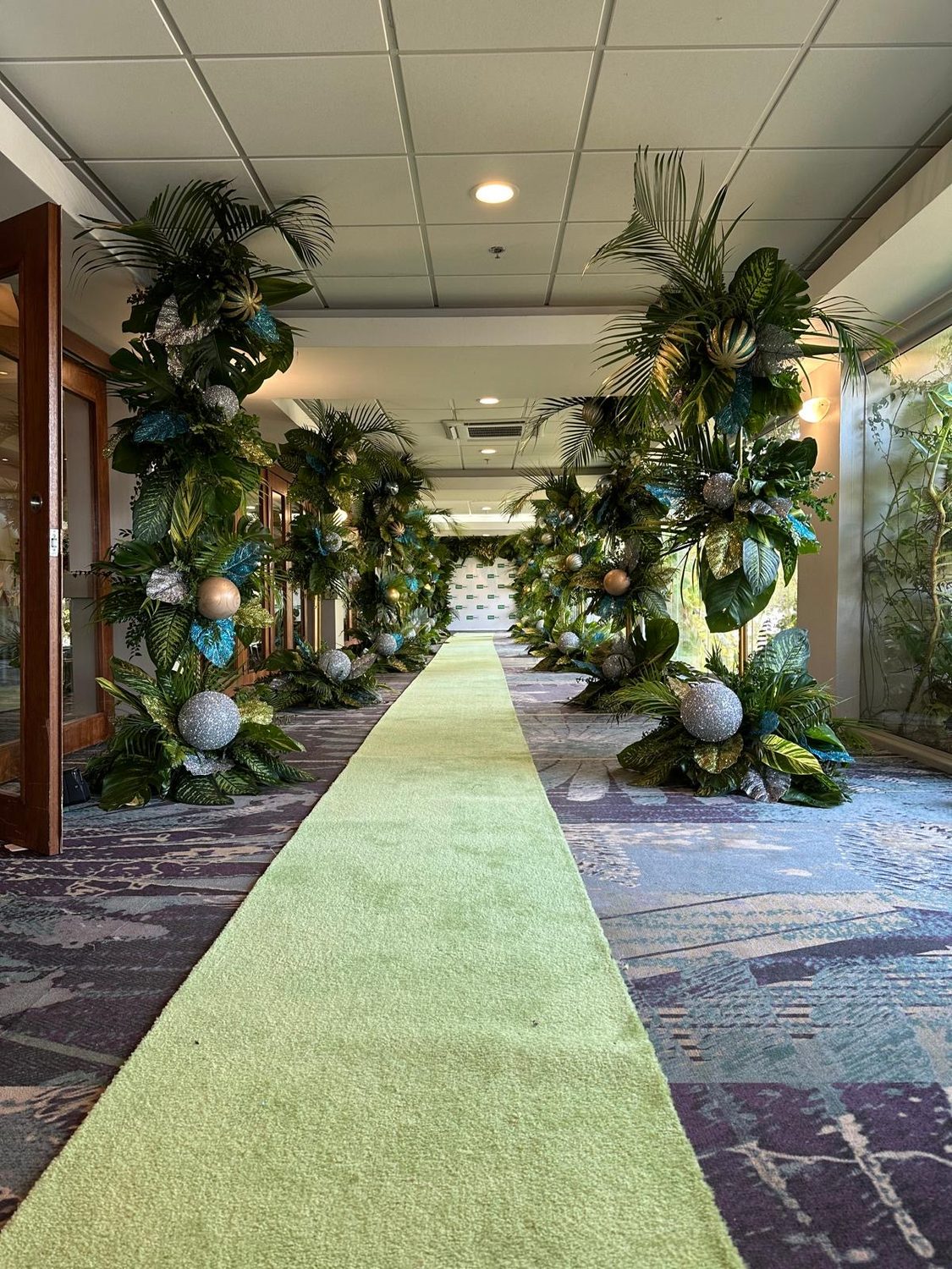Green floral entrance aisle for a private event at Vivo Beach Club