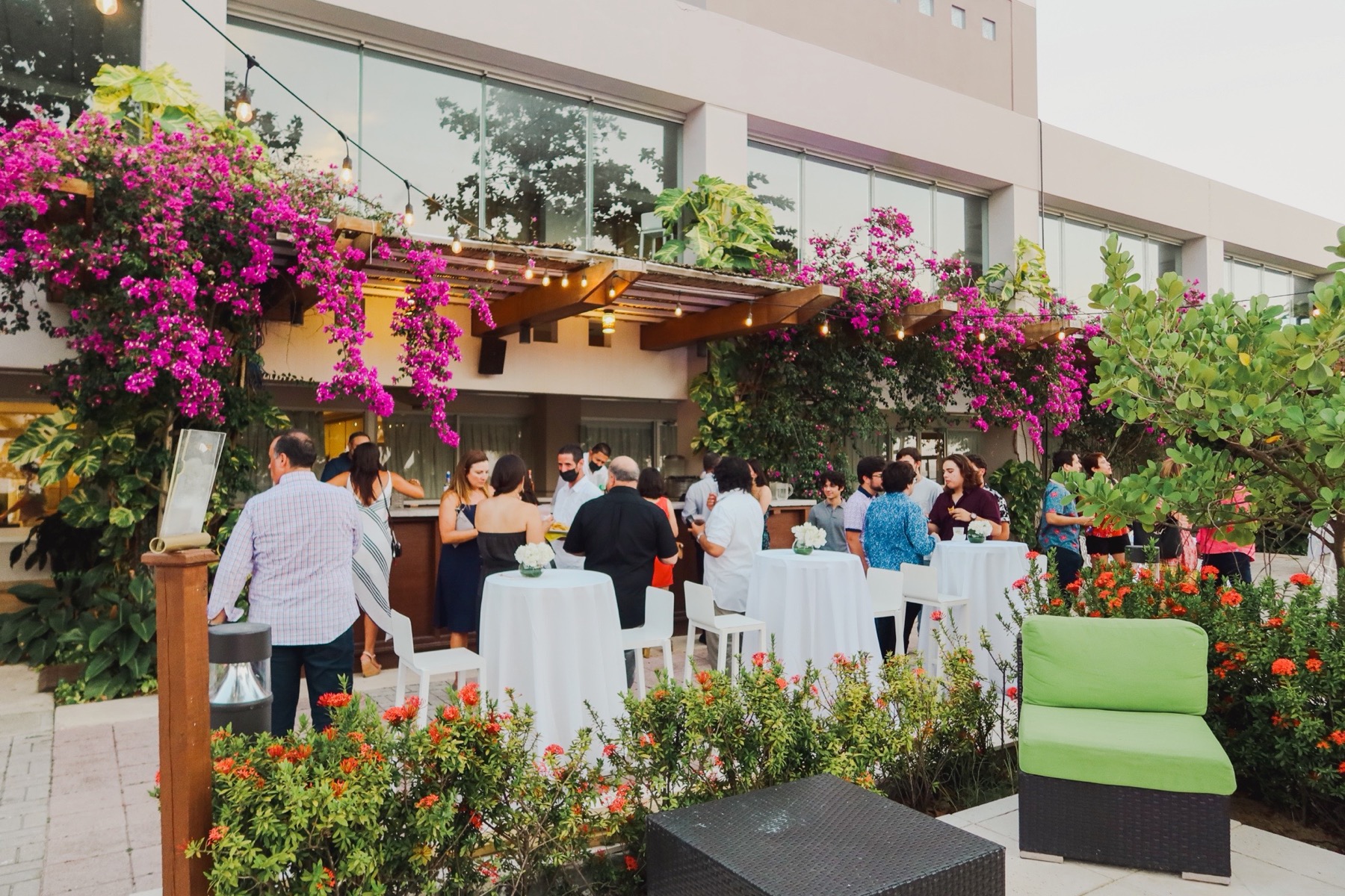 Outdoor garden reception at Vivo Beach Club with guests and tropical flowers