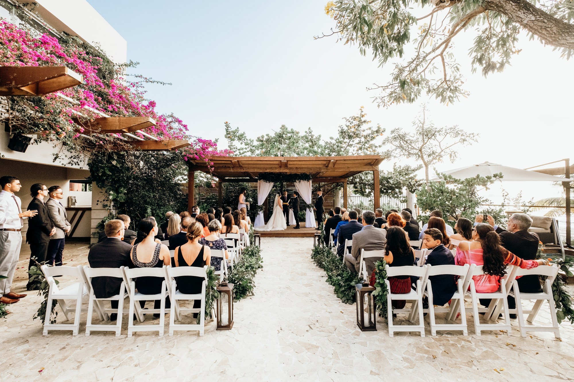 Wedding ceremony with seated guests under the Sea Almond event space at Vivo Beach Club